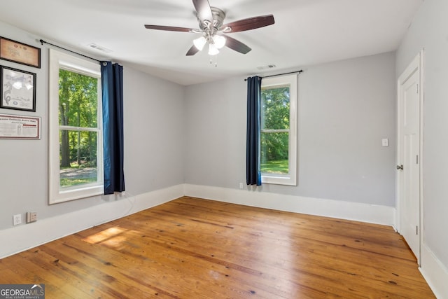 1382 6th Ave, Auburn, GA 30011 - unfurnished room with plenty of natural light, hardwood / wood-style flooring, and a ceiling fan