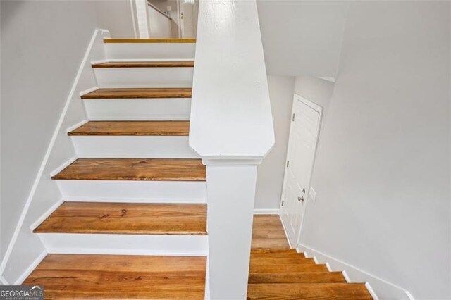 835 Navajo, Covington, GA 30016 - stairway with baseboards and wood finished floors