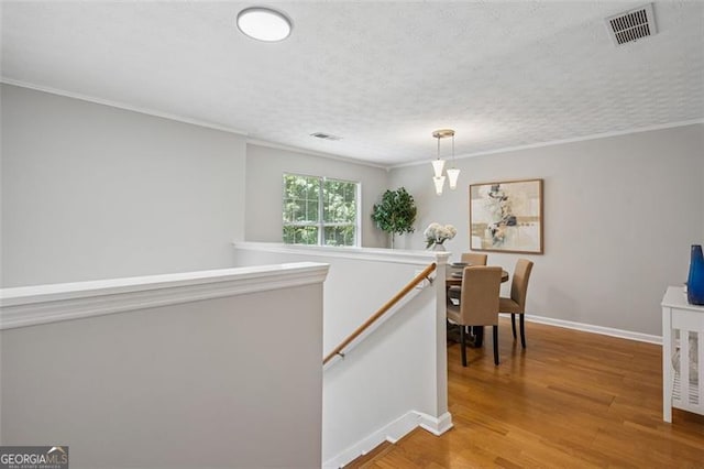 835 Navajo, Covington, GA 30016 - hall featuring an upstairs landing, ornamental molding, and light wood finished floors