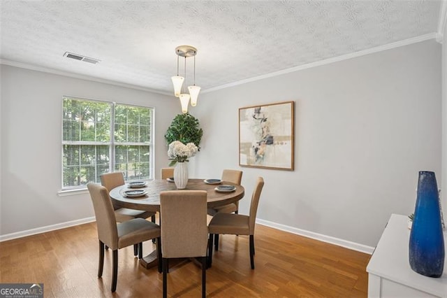 835 Navajo, Covington, GA 30016 - dining area with wood finished floors, crown molding, and a textured ceiling