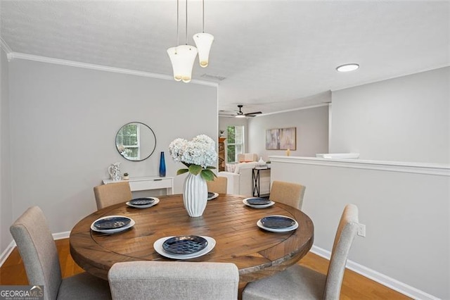 835 Navajo, Covington, GA 30016 - dining area with ornamental molding, a ceiling fan, and wood finished floors