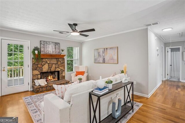 835 Navajo, Covington, GA 30016 - living area with attic access, plenty of natural light, ornamental molding, a ceiling fan, and wood finished floors
