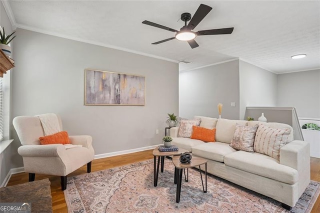 835 Navajo, Covington, GA 30016 - living room featuring wood finished floors, ceiling fan, and ornamental molding