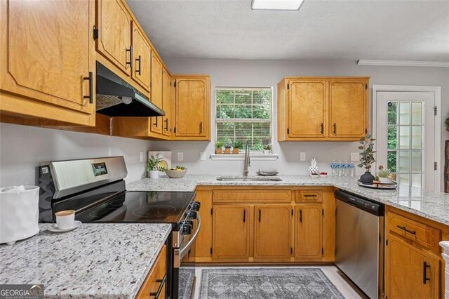 835 Navajo, Covington, GA 30016 - kitchen with appliances with stainless steel finishes, under cabinet range hood, plenty of natural light, light stone counters, and crown molding