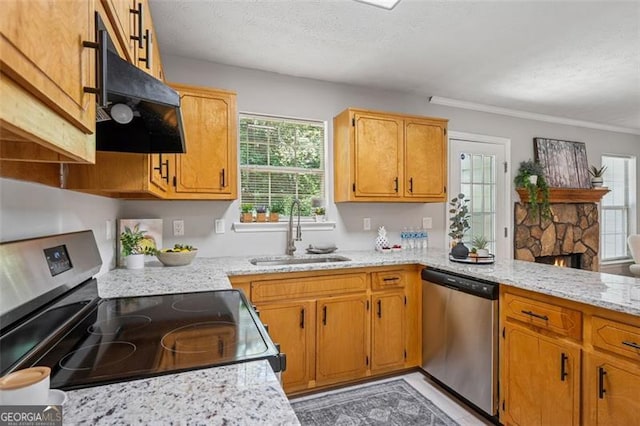 835 Navajo, Covington, GA 30016 - kitchen with stainless steel appliances, under cabinet range hood, a fireplace, light stone countertops, and a peninsula