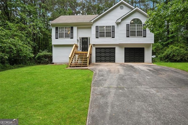835 Navajo, Covington, GA 30016 - bi-level home featuring an attached garage, a front lawn, and concrete driveway