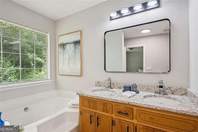 835 Navajo, Covington, GA 30016 - bathroom with healthy amount of natural light, double vanity, and a bath