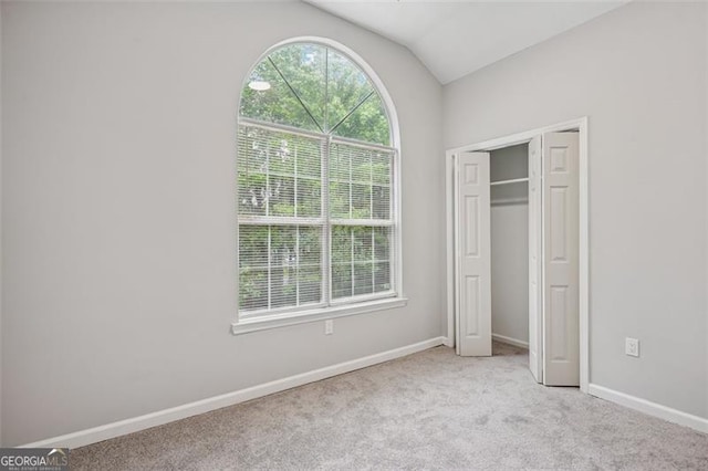835 Navajo, Covington, GA 30016 - unfurnished bedroom featuring vaulted ceiling, carpet floors, and a closet