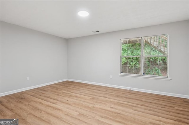 835 Navajo, Covington, GA 30016 - unfurnished room with baseboards and light wood finished floors