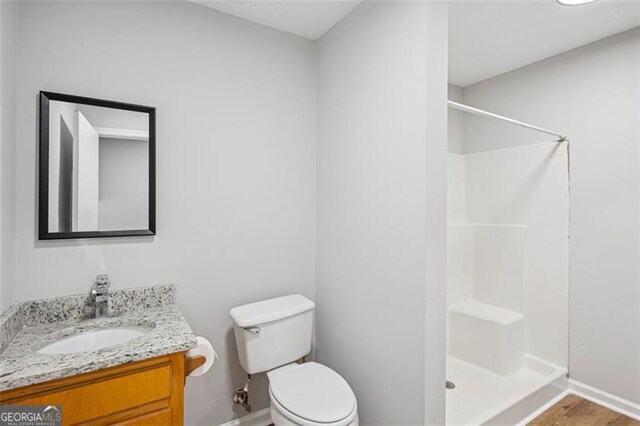 835 Navajo, Covington, GA 30016 - full bathroom with a shower stall, vanity, and wood finished floors