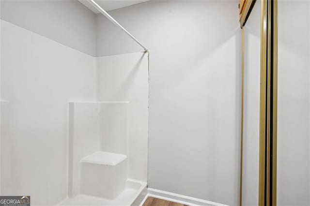 835 Navajo, Covington, GA 30016 - full bathroom featuring a shower and wood finished floors