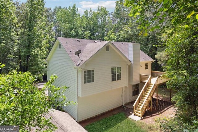 835 Navajo, Covington, GA 30016 - back of property featuring stairway, a wooden deck, and a chimney