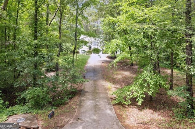 835 Navajo, Covington, GA 30016 - view of street featuring a wooded view