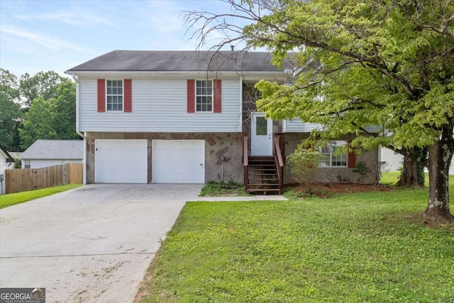 946 Redan Trce, Stone Mountain, GA 30088 - bi-level home featuring an attached garage, driveway, and stone siding