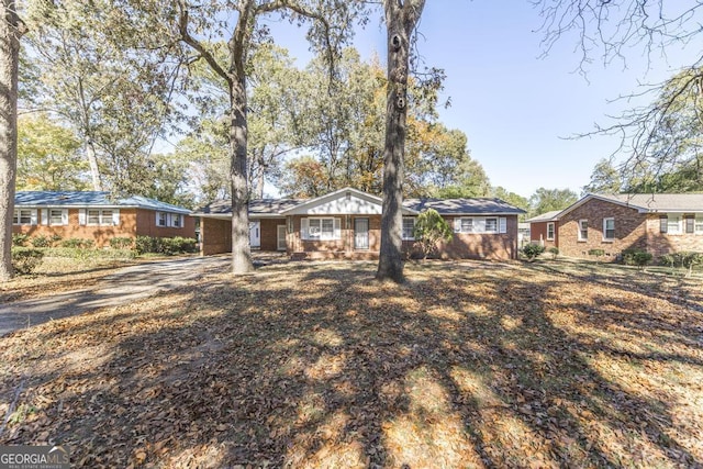 312 Sparta St, Warner Robins, GA 31088 - view of front of property featuring asphalt driveway, an attached carport, and brick siding