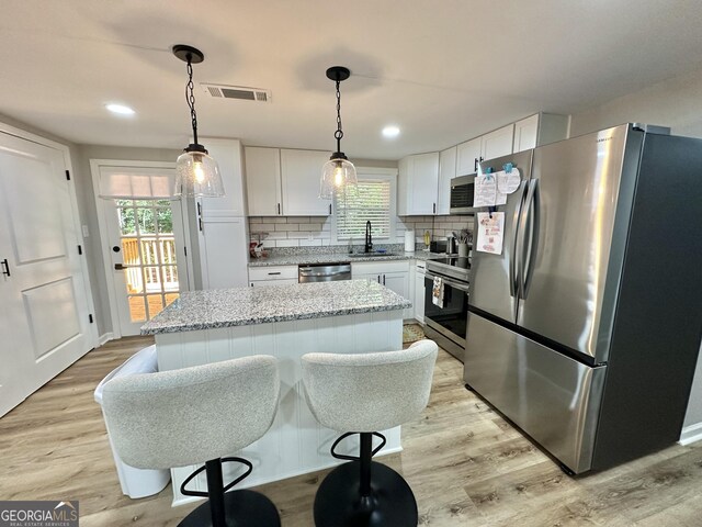 2165 S River Rd, Franklin, GA 30217 - kitchen with stainless steel appliances, a sink, white cabinetry, light wood-style flooring, and recessed lighting