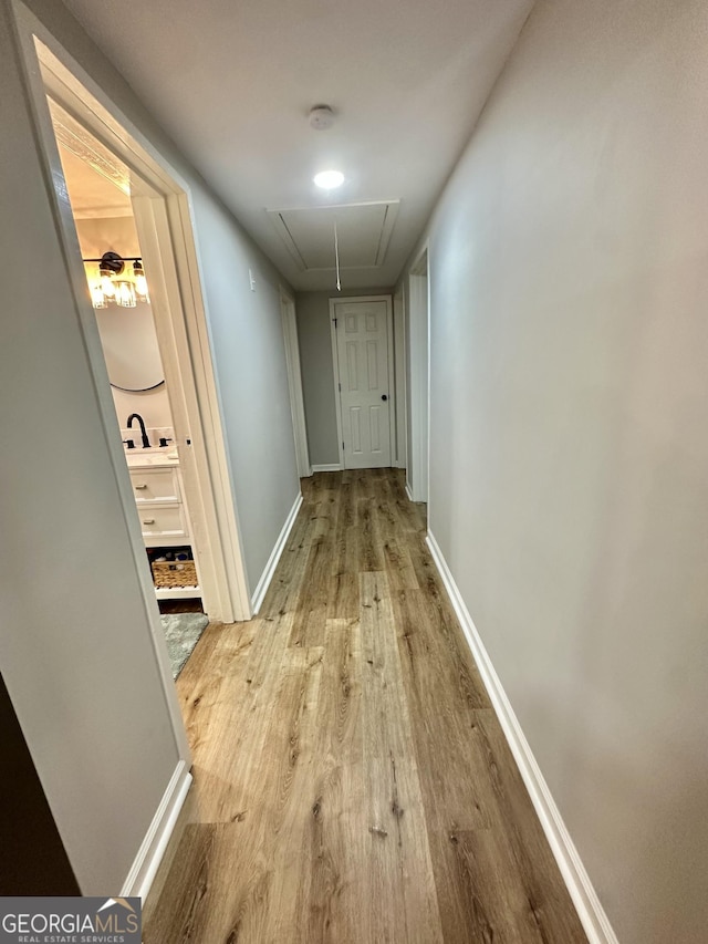 2165 S River Rd, Franklin, GA 30217 - hallway featuring attic access, light wood finished floors, baseboards, and a sink