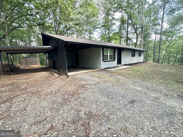 2165 S River Rd, Franklin, GA 30217 - view of front of home featuring concrete block siding, a carport, driveway, and a shingled roof