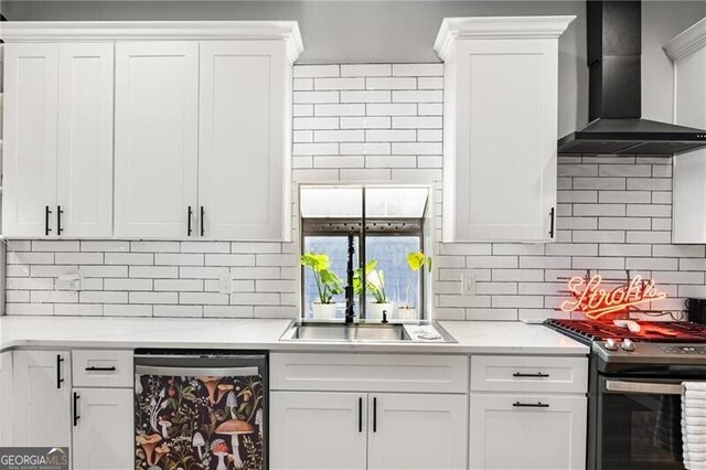 611 Pickett St SE, Atlanta, GA 30316 - kitchen with dishwasher, wall chimney exhaust hood, stainless steel gas stove, tasteful backsplash, and white cabinets