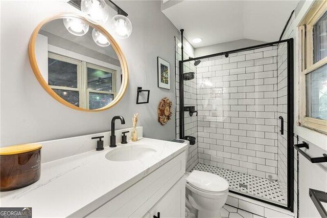 611 Pickett St SE, Atlanta, GA 30316 - bathroom featuring a stall shower, vanity, and vaulted ceiling