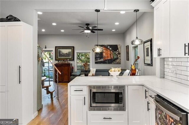 611 Pickett St SE, Atlanta, GA 30316 - kitchen with stainless steel appliances, a peninsula, a ceiling fan, recessed lighting, and light stone countertops