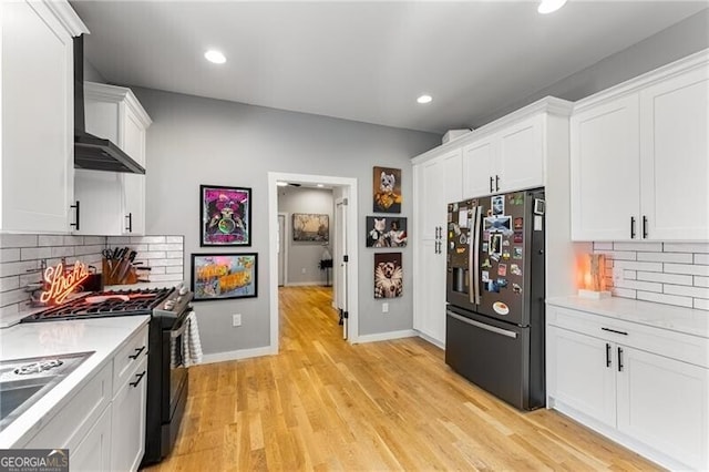 611 Pickett St SE, Atlanta, GA 30316 - kitchen with stainless steel fridge with ice dispenser, gas stove, light countertops, white cabinetry, and recessed lighting