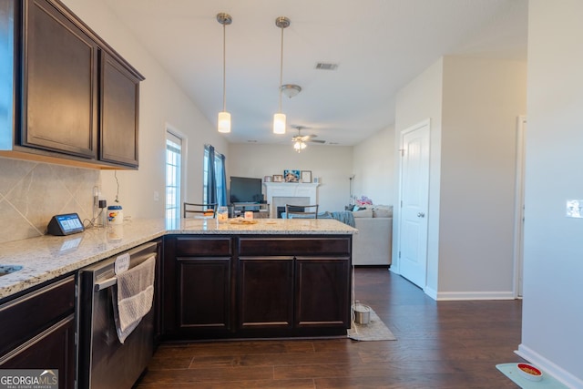 247 Morgan Field Blvd, Ludowici, GA 31316 - kitchen with stainless steel dishwasher, a peninsula, dark wood-style floors, decorative backsplash, and a ceiling fan