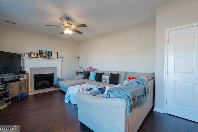 247 Morgan Field Blvd, Ludowici, GA 31316 - living room featuring a ceiling fan, dark wood-style floors, a tile fireplace, and baseboards