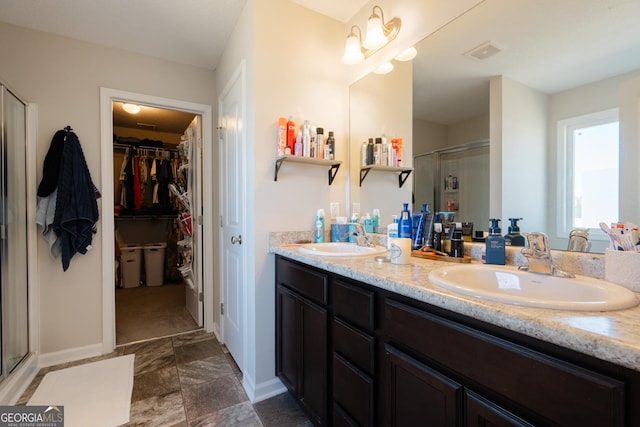 247 Morgan Field Blvd, Ludowici, GA 31316 - full bath featuring a shower stall, double vanity, a spacious closet, and baseboards