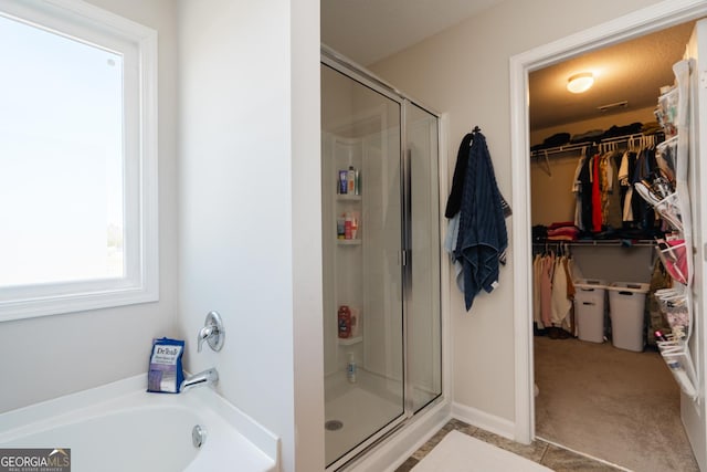 247 Morgan Field Blvd, Ludowici, GA 31316 - full bathroom featuring a shower stall, a walk in closet, and a garden tub