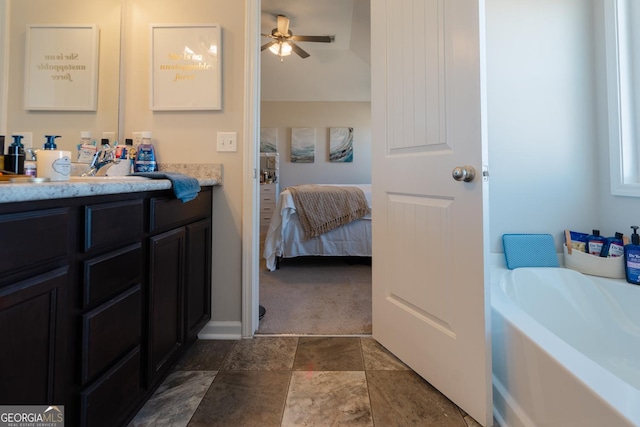 247 Morgan Field Blvd, Ludowici, GA 31316 - bathroom featuring connected bathroom, vanity, a bath, ceiling fan, and stone finish floors