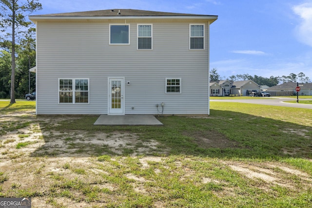 247 Morgan Field Blvd, Ludowici, GA 31316 - rear view of house with a patio area and a lawn