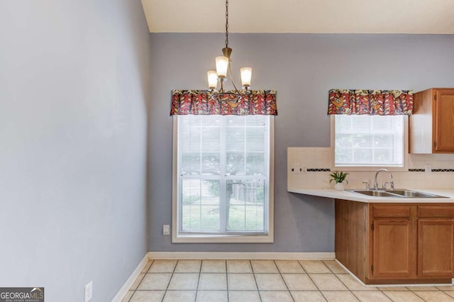 3585 Berkeley Park Ct, Duluth, GA 30096 - kitchen with a sink, a chandelier, tasteful backsplash, and light countertops