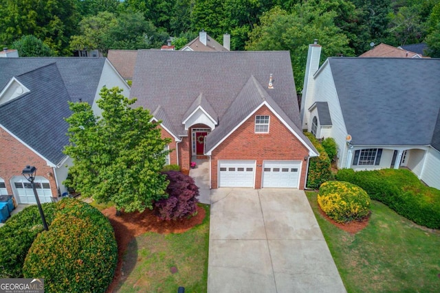 3585 Berkeley Park Ct, Duluth, GA 30096 - view of front of property with driveway, brick siding, a chimney, a garage, and a front lawn