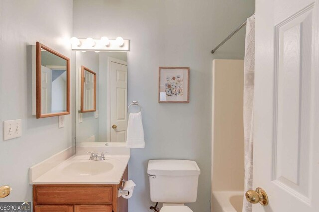 3585 Berkeley Park Ct, Duluth, GA 30096 - full bathroom with vanity, toilet, and shower / bath combo with shower curtain
