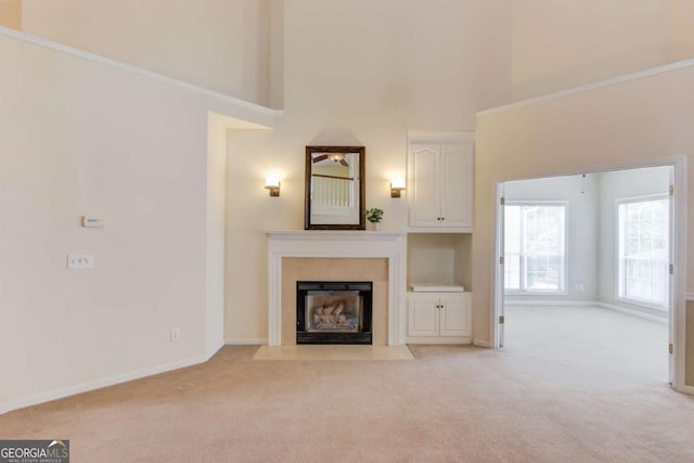 3585 Berkeley Park Ct, Duluth, GA 30096 - unfurnished living room featuring light colored carpet, a towering ceiling, a fireplace with flush hearth, and baseboards