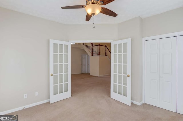 3585 Berkeley Park Ct, Duluth, GA 30096 - unfurnished bedroom with carpet flooring, a closet, baseboards, french doors, and ceiling fan