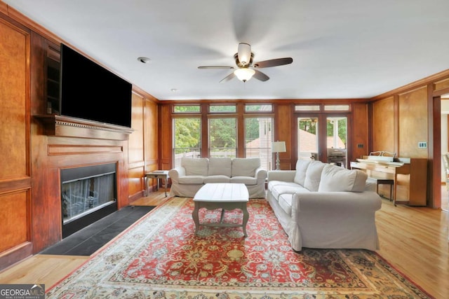 1925 Stonewyck Ct, Cumming, GA 30041 - living room featuring a ceiling fan, a fireplace with flush hearth, wood finished floors, and crown molding