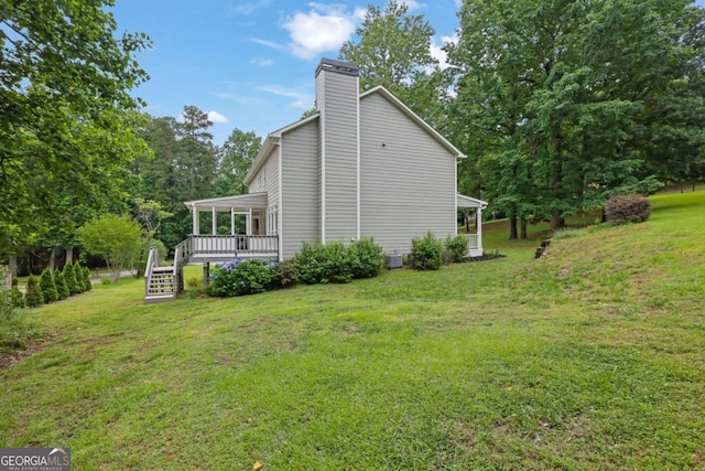 1925 Stonewyck Ct, Cumming, GA 30041 - view of home's exterior with a yard, a chimney, and a wooden deck