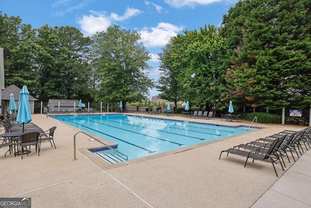 1925 Stonewyck Ct, Cumming, GA 30041 - community pool with a patio area and view of scattered trees