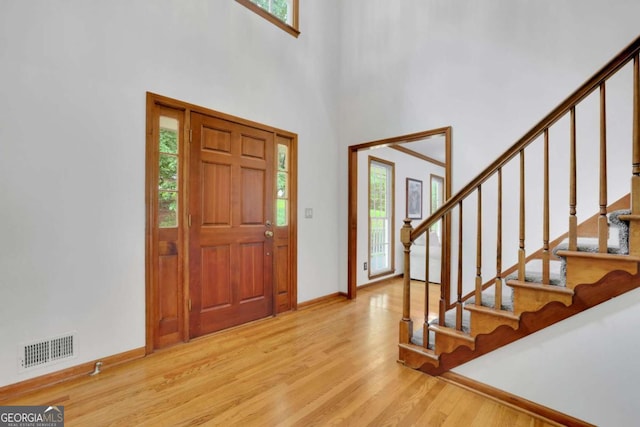 1925 Stonewyck Ct, Cumming, GA 30041 - foyer entrance with wood finished floors, stairway, and a high ceiling