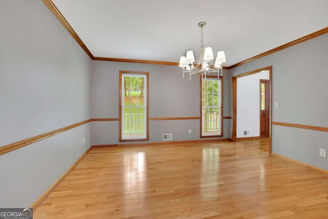 1925 Stonewyck Ct, Cumming, GA 30041 - empty room featuring a chandelier, crown molding, and wood finished floors