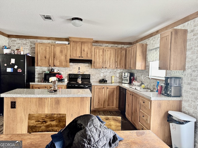 342 Wellington Dr, Byron, GA 31008 - kitchen featuring under cabinet range hood, a sink, light countertops, and black appliances