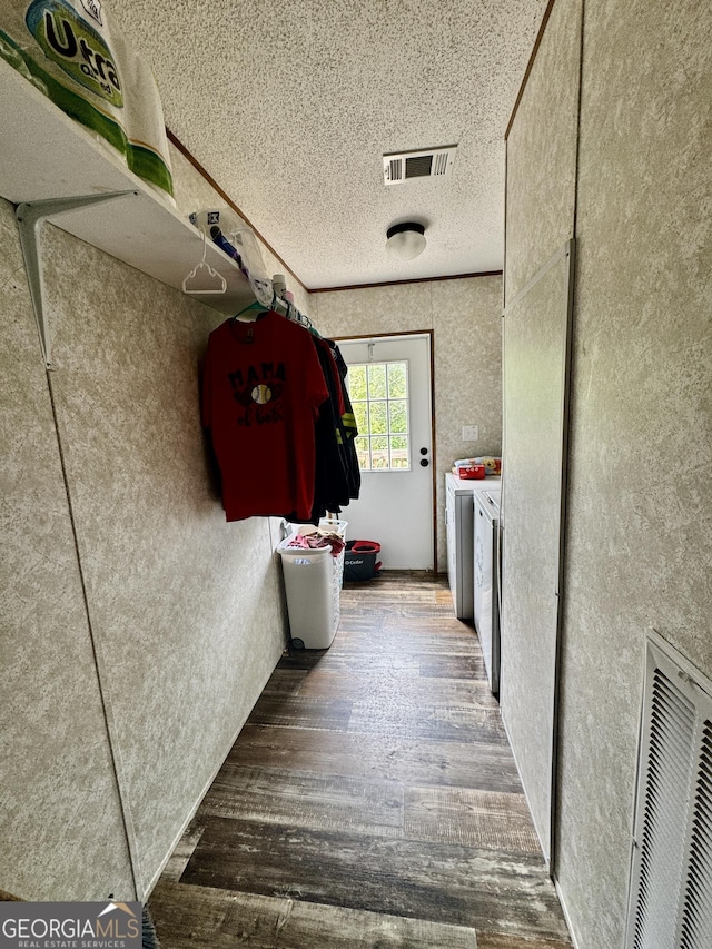 342 Wellington Dr, Byron, GA 31008 - hallway featuring independent washer and dryer, wood finished floors, and a textured ceiling
