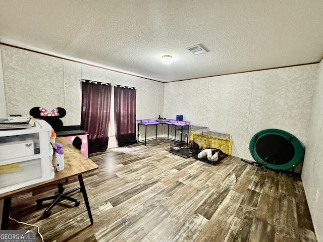 342 Wellington Dr, Byron, GA 31008 - home office with wood finished floors, a textured ceiling, crown molding, and a textured wall