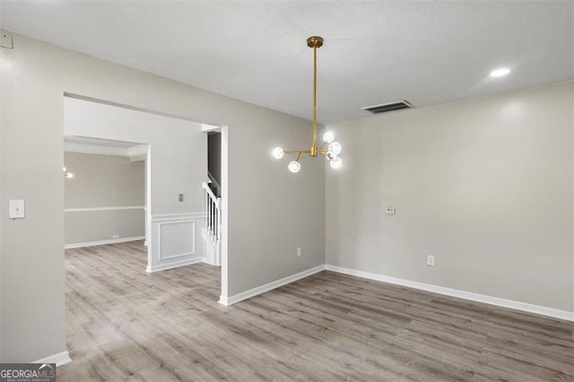 3385 Amhurst Pkwy, South Fulton, GA 30349 - unfurnished room with wood finished floors, stairs, a chandelier, baseboards, and recessed lighting