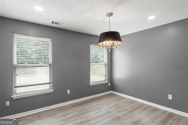 3385 Amhurst Pkwy, South Fulton, GA 30349 - empty room featuring a textured ceiling, wood finished floors, a chandelier, recessed lighting, and baseboards