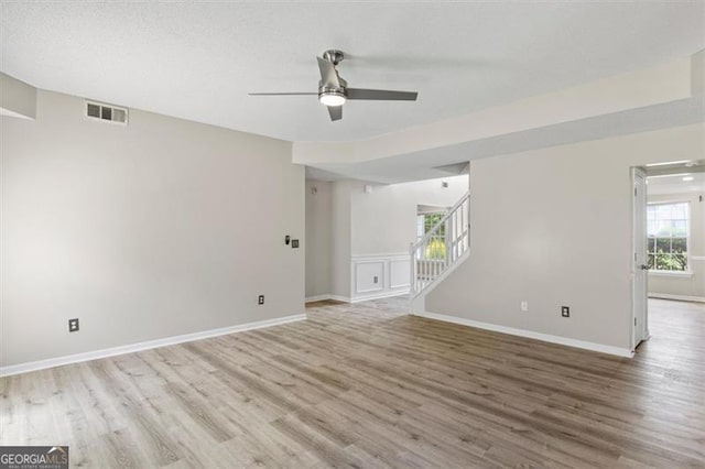 3385 Amhurst Pkwy, South Fulton, GA 30349 - spare room with wood finished floors, ceiling fan, stairs, and baseboards