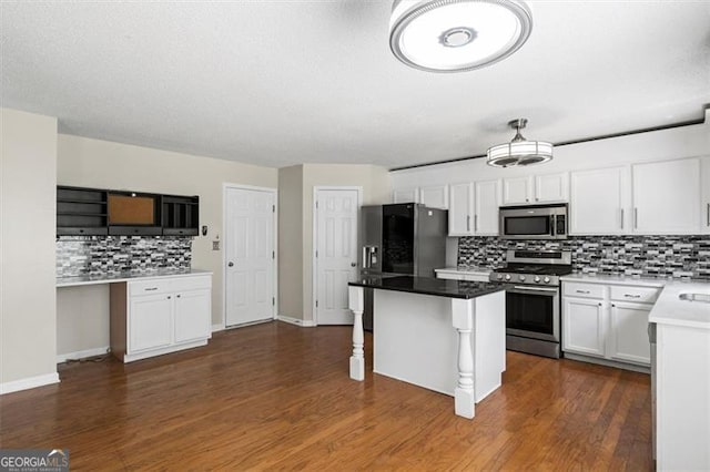 3385 Amhurst Pkwy, South Fulton, GA 30349 - kitchen with stainless steel appliances, decorative backsplash, white cabinetry, a kitchen island, and dark wood-style flooring