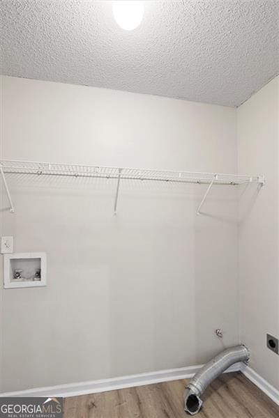 3385 Amhurst Pkwy, South Fulton, GA 30349 - laundry room with hookup for an electric dryer, wood finished floors, hookup for a washing machine, a textured ceiling, and baseboards